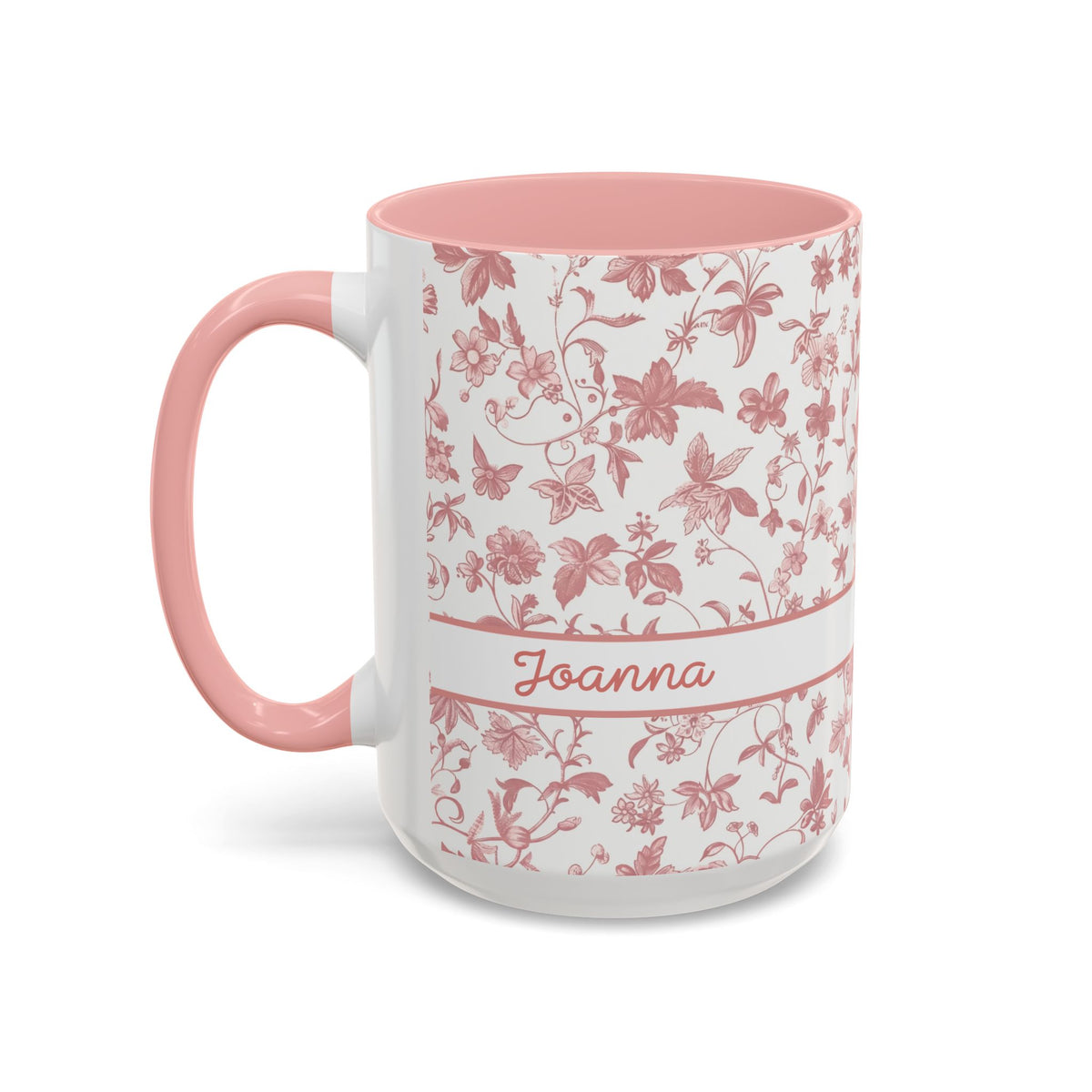 A white ceramic 15oz mug with a pink floral chinoiserie pattern, a pink handle, and a pink interior. A white band around the middle features the name 'Joanna' in pink script. Left handle view.