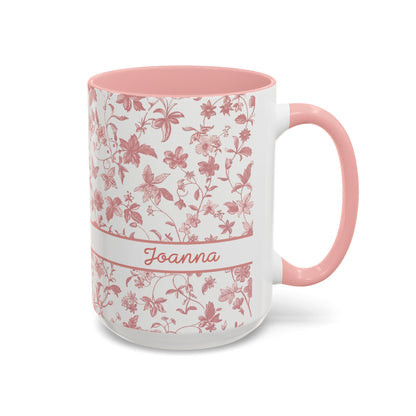 A white ceramic 15oz mug with a pink floral chinoiserie pattern, a pink handle, and a pink interior. A white band around the middle features the name 'Joanna' in pink script. Right handle view.