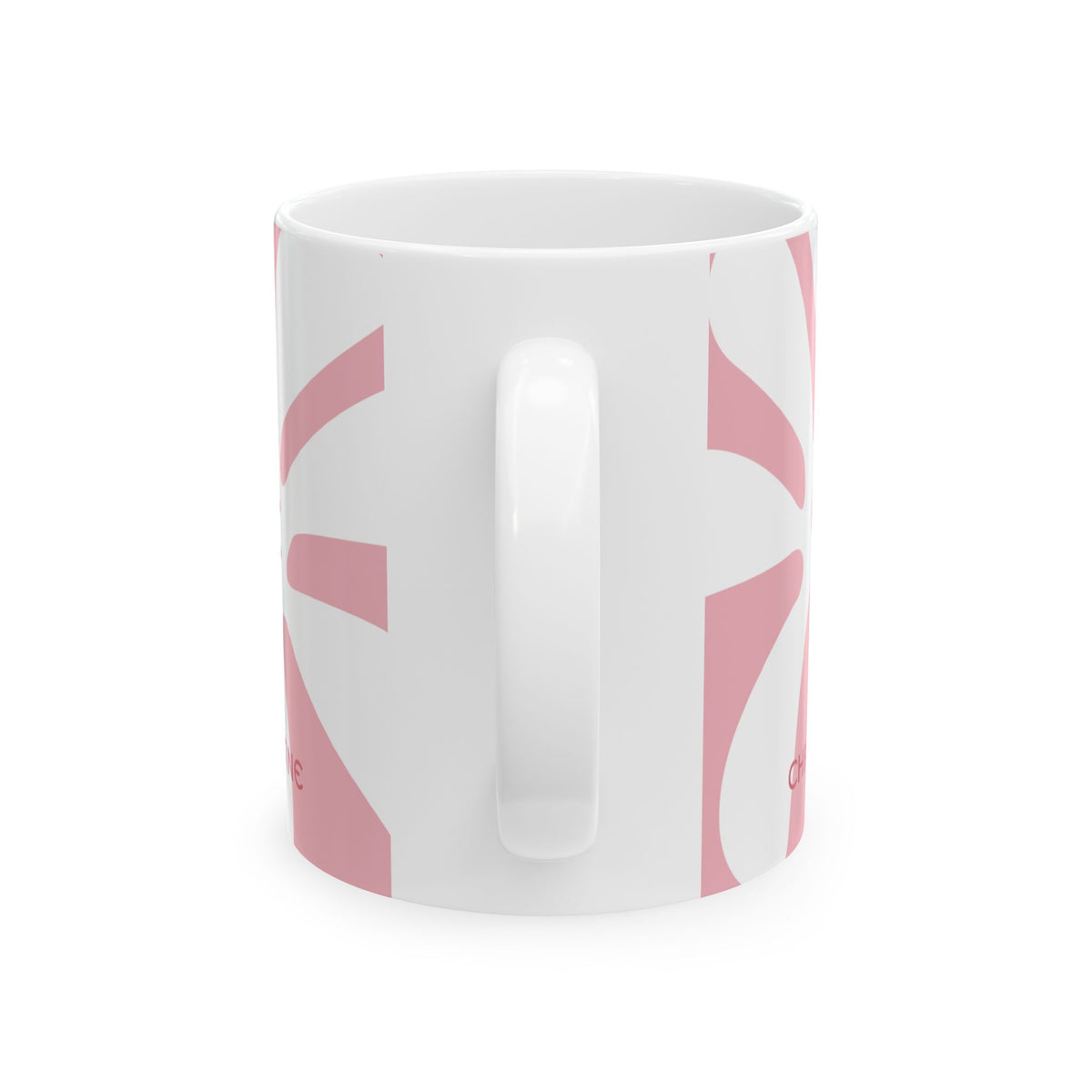 View of the handle of a white ceramic 11oz mug with a pink graphic pattern, shown against a plain white background.