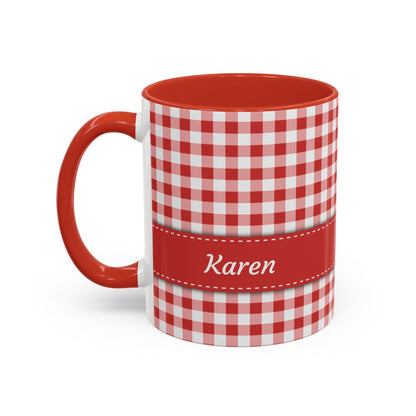 A white ceramic 11oz mug with a red and white gingham check pattern, a solid red handle and interior, and a red horizontal band around the middle featuring the name 'Rebecca' in white script. Left handle view.