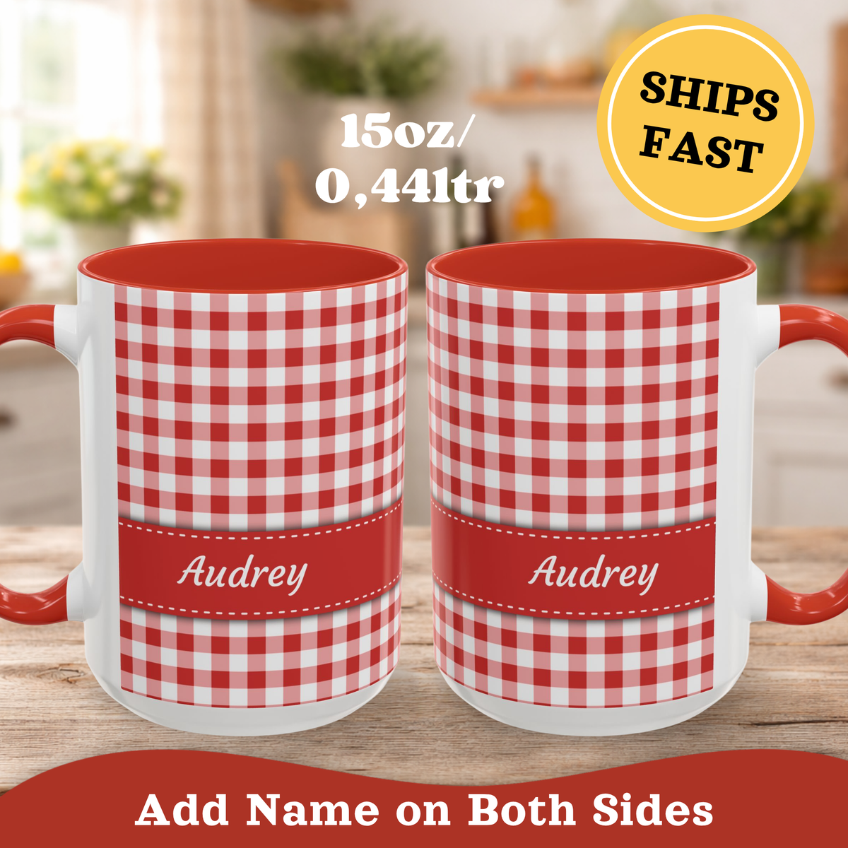 Two personalized 15 oz mugs with a red and white gingham pattern and a red band at the bottom displaying the name 'Audrey' in white script. The mugs have red interiors and handles, shown on a wooden table with a blurred kitchen background.