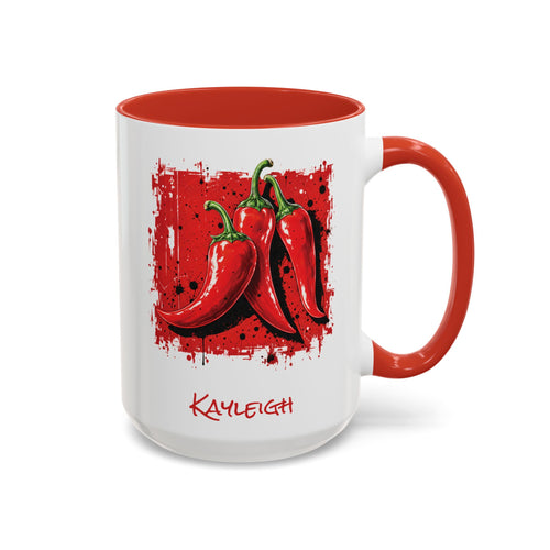 A white ceramic 15oz mug with a red interior, red handle, and a red graphic of three chili peppers on the front, with the name 'KAYLEIGH' printed in red below the artwork.