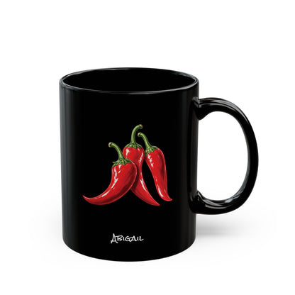 A glossy black ceramic mug featuring an illustration of three red chili peppers with green stems and the name 'Abigail' printed in white capital script below, set against a plain white background. Right handle view.