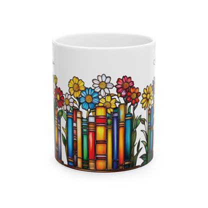 A white ceramic 11oz mug featuring a colorful illustration of flowers growing out of book spines, on a plain white background. No handle view.