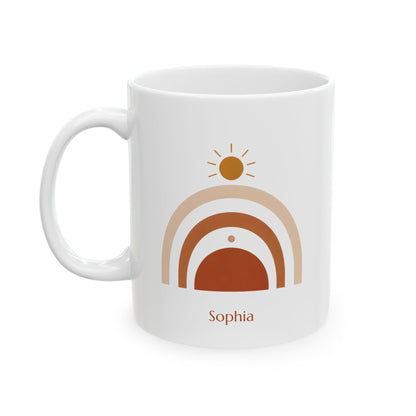 A white ceramic 11oz mug with a minimalist retro design featuring a sun, arches, and the name 'Sophia' printed in brown and beige, left handle view.