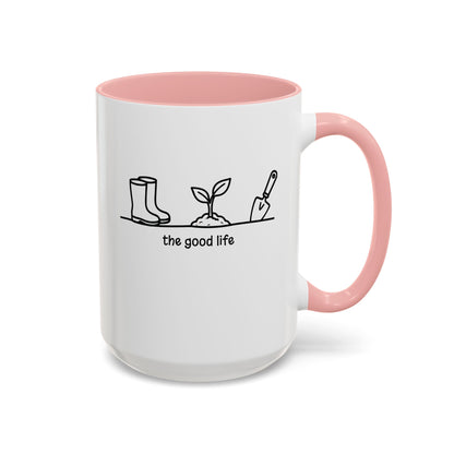 White accent mug with pink interior, 'the good life' quote and garden tool line art, 15oz right side view.