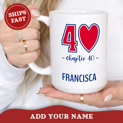 A white ceramic 15oz mug with a red '40' graphic with blue outlines, and blue 'chapter 40' in script font, and the name 'FRANCISCA' in capital letters printed on it, held by a person. A red 'SHIPS FAST' badge is on the top left, and a red banner at the bottom says 'ADD YOUR NAME'.
