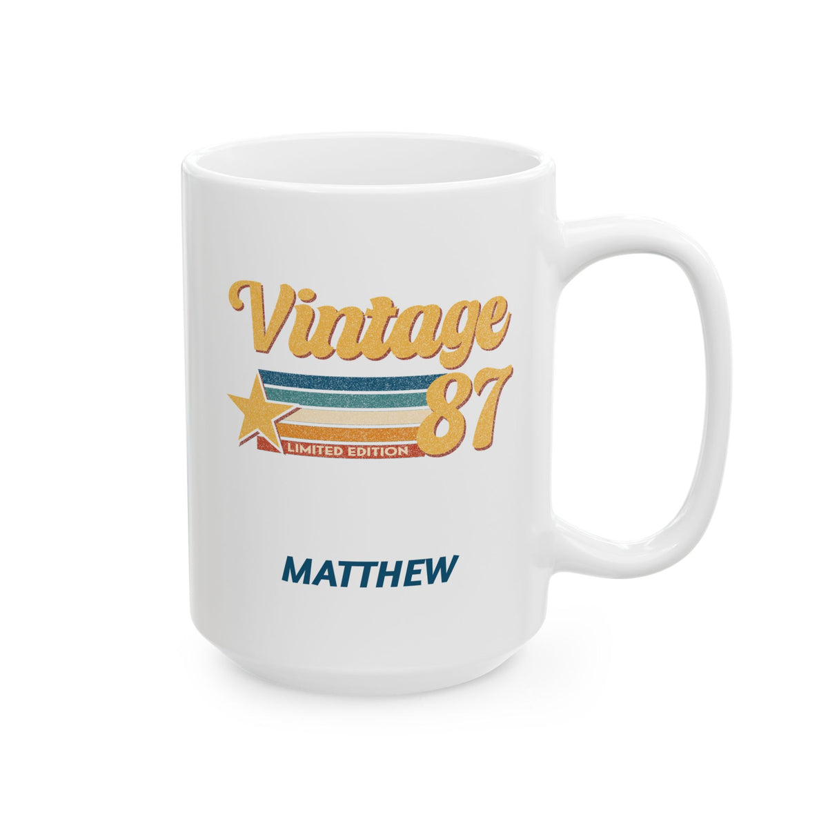 A white ceramic 15oz mug with a 'Vintage 87' graphic in gold, blue, and orange, featuring the name 'MATTHEW' printed below in blue, shown on a clean white background. Right handle view.
