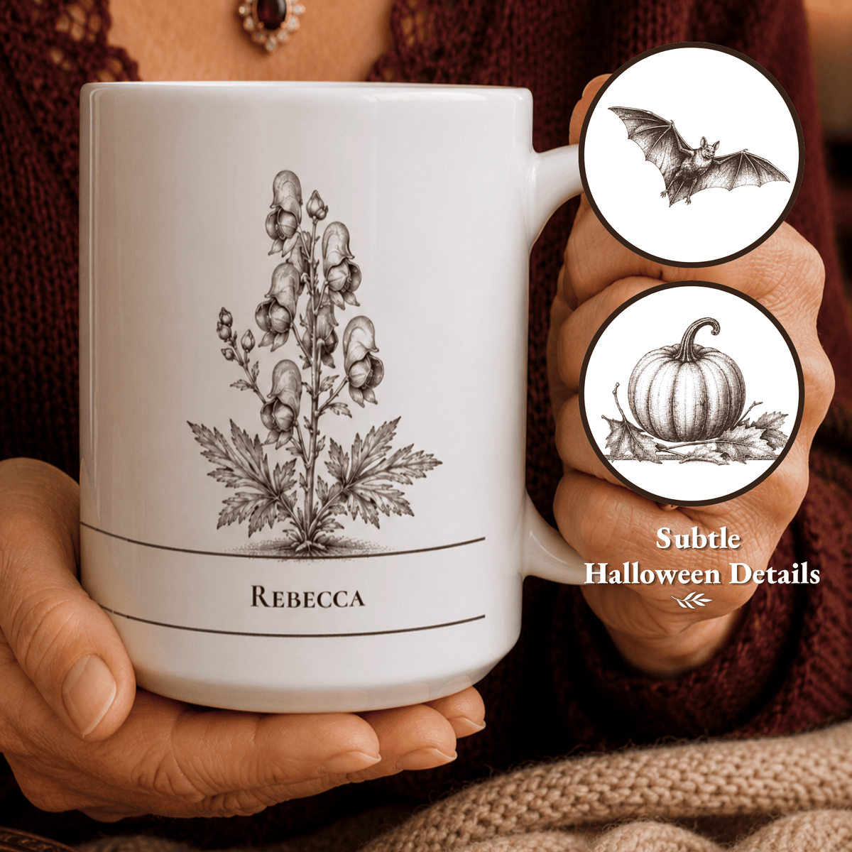 A white ceramic mug with a vintage brown botanical wolfsbane illustration and the name 'REBECCA' printed on it, held by hands wearing a dark brown knit sweater. Two circular callout graphics on the right show additional subtle Halloween-themed details, including a bat and a pumpkin.