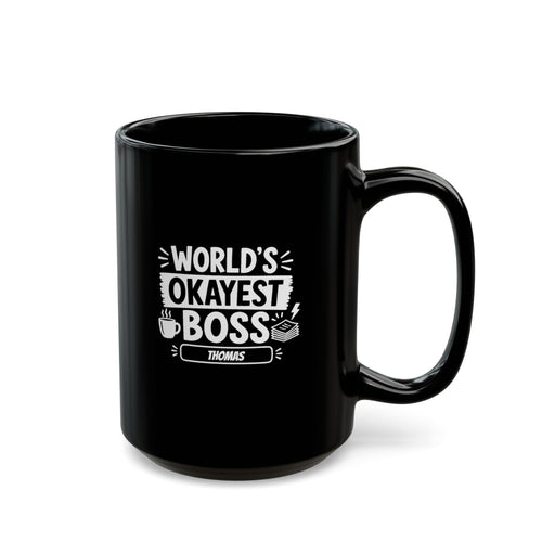 Black 15oz mug with white illustrative typographic design saying 'World's Okayest Boss' and a personalized name at the bottom, right handle view. Mug is placed on a white background.