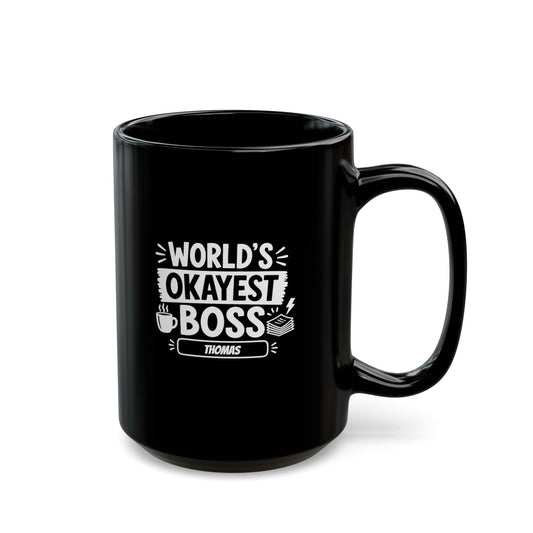 Black 15oz mug with white illustrative typographic design saying 'World's Okayest Boss' and a personalized name at the bottom, right handle view. Mug is placed on a white background.