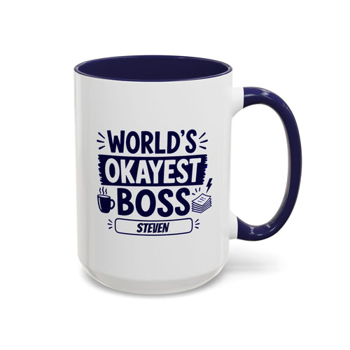 A white ceramic 15oz mug with a navy interior and handle, printed with the bold text 'World's Okayest Boss' above a name plate reading 'Steven'. Right handle view.